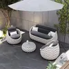 An outdoor patio set with a sofa, two chairs, and a coffee table under a large umbrella. Produktbild-Vorschau