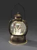 A decorative snow globe lantern with a snowman family inside, lit from below. Produktbild-Vorschau