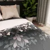 A close-up view of a bed with a duvet cover featuring a floral pattern. Produktbild-Vorschau