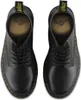 A top-down view of a pair of black Dr. Martens boots. Voir les images du produit