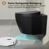 A black wall-mounted toilet with a white robot vacuum cleaner cleaning the floor beneath it. Náhľad obrázku produktu