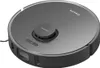 A close-up shot of a dark gray robot vacuum cleaner. The vacuum has a circular shape with a prominent raised cylindrical unit in the center, which has text on it. There are also two illuminated buttons on the top surface. The front of the vacuum features a Náhľad obrázku produktu