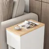 A close-up of a narrow nightstand next to a sofa, with a magazine and a cup of coffee on top. Produktbild-Vorschau