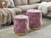 Two pink velvet ottomans with gold bases are placed on a rug in front of a sectional sofa. Náhled obrázku produktu