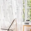 A sheer curtain with cloud patterns hangs in front of a window, with a chair and a small decorative item on the windowsill. Produktbild-Vorschau