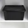 A black storage container with a lid sits on a white shelf. Produktbild-Vorschau