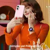 A woman is taking a selfie with a pink phone case and applying makeup. Náhled obrázku produktu