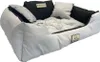 A light gray dog bed with black accents and pillows, shown from a slightly elevated side angle. Náhľad obrázku produktu