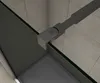 A close-up view of a shower enclosure's corner, showing a black metal support arm attached to a glass panel. Produktbild-Vorschau
