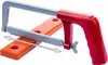 A toy hacksaw and a wooden block with holes, presented against a white background. Produktbild-Vorschau