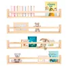 Four wooden shelves are displayed against a white background, each holding various items like books, picture frames, and stuffed animals. Náhľad obrázku produktu