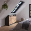 A bedroom with slanted ceilings, featuring a storage unit under a skylight and a bed. Náhled obrázku produktu