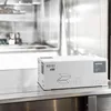 A white cardboard box with product information printed on it, placed on a stainless steel counter in what appears to be a commercial kitchen or laboratory setting. Náhled obrázku produktu