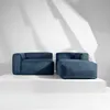 Two blue sofas are displayed on a white platform against a white wall with shadows. Produktbild-Vorschau