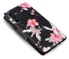 A black flip phone case with a pink hibiscus floral pattern. Produktbild-Vorschau