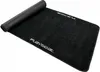 A black Playseat floor mat is shown rolled up on one end and unrolled on the other. Produktbild-Vorschau