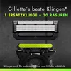 Close-up of Gillette razor blades and handle against a dark, textured background. Produktbild-Vorschau