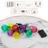 A string of colorful LED light bulbs with a solar panel. Produktbild-Vorschau