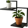 A black metal plant stand with two shelves, holding two potted plants. Produktbild-Vorschau