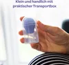 A hand holds a small blue and clear plastic product, likely a medical device, against a blurred background. Náhled obrázku produktu