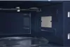 Interior view of a microwave oven, showing the heating element, turntable, and side wall. Anteprima dell’immagine prodotto