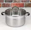 A stainless steel cooking pot with a glass lid is shown on a countertop in front of a brick wall. Voir les images du produit