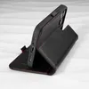 A black leather iPhone case with red stitching is shown in a standing position. Produktbild-Vorschau