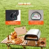 A portable pizza oven set up on a wooden table outdoors, with a pizza and bread basket. Produktbild-Vorschau