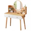 A modern vanity table with a round mirror, two drawers, and shelves displaying cosmetics and decorative items. Podgląd zdjęcia produktu