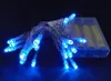 A string of blue LED lights with a battery pack in the background. Produktbild-Vorschau
