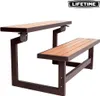 A brown metal and tan wooden picnic table with attached benches, shown from a diagonal angle against a white background. Podgląd zdjęcia produktu