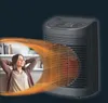 A woman relaxing on a couch while a space heater blows warm air towards her. Anteprima dell’immagine prodotto