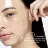A close-up of a woman's face with a clear sheet mask applied, and a hand pulling a thread from the mask. Produktbild-Vorschau