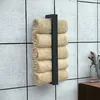 A black metal towel rack mounted on a tiled wall, holding several rolled beige towels. Anteprima dell’immagine prodotto