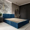 A bedroom with a dark blue upholstered bed frame and wooden slats. Produktbild-Vorschau