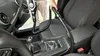 A person is vacuuming the interior of a car with a handheld vacuum cleaner. Produktbild-Vorschau
