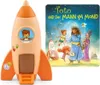 A toy rocket and a book titled 'Toto und der Mann im Mond' are displayed together. Produktbild-Vorschau