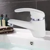 A white faucet in a bathroom sink with water. Produktbild-Vorschau