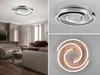 A collage of images showing a modern spiral-shaped LED ceiling light fixture in a living room setting and close-up views. Anteprima dell’immagine prodotto