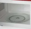 Interior view of a microwave oven, showing the glass turntable. Anteprima dell’immagine prodotto