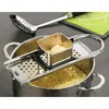 A stainless steel steamer insert is placed over a pot filled with sliced potatoes, with a slotted spoon resting on a green cloth in the background. Produktbild-Vorschau