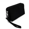 A black clutch bag with a wrist strap is shown against a white background. Produktbild-Vorschau