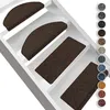 Several brown stair mats are placed on white stairs. Anteprima dell’immagine prodotto