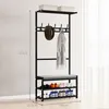 A black metal coat rack with a shoe shelf and a bench, displayed in a room with a window in the background. Produktbild-Vorschau