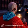 A person is running at night with headphones on. Náhled obrázku produktu