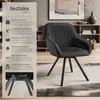 A black upholstered chair with metal legs is shown in a room setting, with text describing its features on the left side. Produktbild-Vorschau