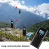 Walkie-talkies are shown in a mountainous landscape, illustrating their long communication range. Anteprima dell’immagine prodotto