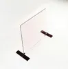 A clear glass panel with dark brown bases, set against a white background. Produktbild-Vorschau