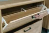 A hand is shown opening a drawer on a wooden cabinet. Produktbild-Vorschau