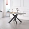 A dining table with a marble-effect top and black criss-cross legs, set in a well-lit room with white walls and a window with blinds. Produktbild-Vorschau